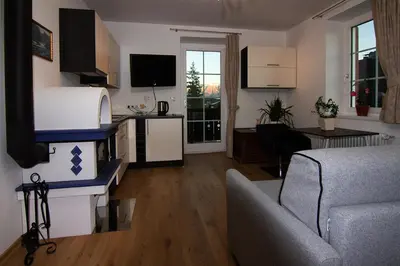a small living room with a couch and a kitchen at Gasthaus Babsi in Soprabolzano