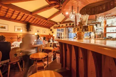 a restaurant with people sitting at a bar at Gasthaus Babsi in Soprabolzano