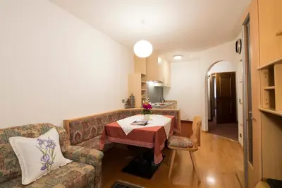 a living room with a couch and a table at Ciasa Iris in Colfosco
