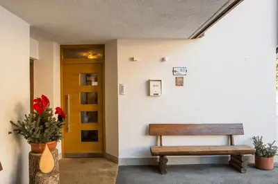 a bench sitting in a hallway next to a door at Ciasa Iris in Colfosco