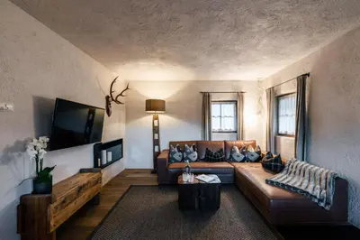 a living room with a couch and a table at Sportony Mountain Lodges in La Villa