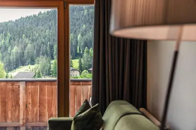 a room with a couch and a window with a view at Ciasa Agreiter in La Villa