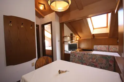 a room with a table and chairs and a window at Apartments Residence Alta Badia in Colfosco