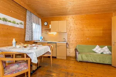 a small kitchen with a table and a couch in a room at Lahnerhof in Campo Tures