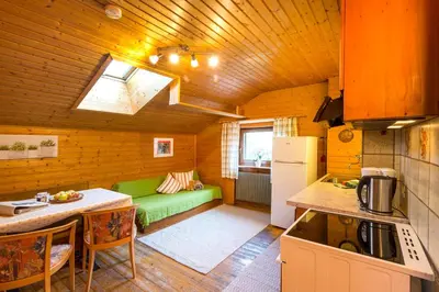 a kitchen with a green couch in a room at Lahnerhof in Campo Tures