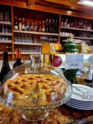 a pie in a glass plate on top of a counter at Hotel Brückenwirt - Al Ponte in Montagna