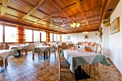 a dining room with tables and chairs at Hotel Brückenwirt - Al Ponte in Montagna