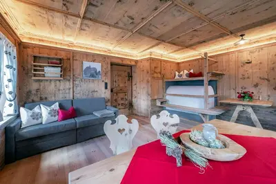 a living room with a couch and a bed at Sigmundhof in Bressanone