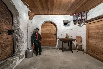 a statue of a man in a room with a table at Sigmundhof in Bressanone