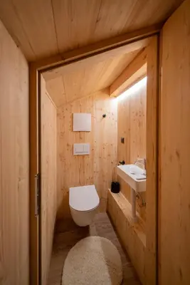 a bathroom with a toilet and a sink at Chalet Silvesterhütte in Seiser Alm