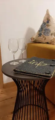 a table with two wine glasses and a menu on it at Residence Maximilian in Vipiteno