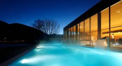 a building at night with blue lights in front of it at Residence Maximilian in Vipiteno