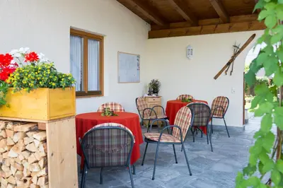 a room with tables and chairs with red table cloths at Hotel B&B Martha in Brunico