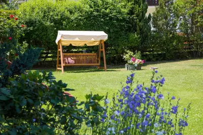 a gazebo in the middle of a garden at Hotel B&B Martha in Brunico