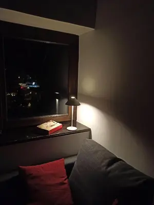 a room with a window with a lamp and a pillow at Mansarda Marmolada Canazei, parking, ski slopes 300m in Alba di Canazei