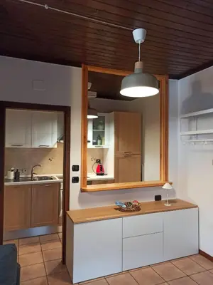 a kitchen with white cabinets and a wooden counter at Mansarda Marmolada Canazei, parking, ski slopes 300m in Alba di Canazei