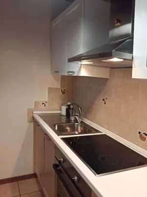 a kitchen with a sink and a counter top at Mansarda Marmolada Canazei, parking, ski slopes 300m in Alba di Canazei