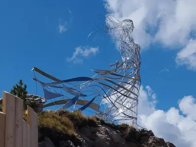 a sculpture of a woman on top of a hill at Mansarda Marmolada Canazei, parking, ski slopes 300m in Alba di Canazei