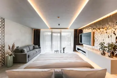 a large bedroom with a large bed and a couch at Quellenhof See Lodge in Saltusio