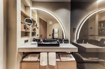 a bathroom with a sink and a mirror at Quellenhof See Lodge in Saltusio