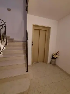 a hallway with stairs and a door in a building at Appartamento Al Borgo in Cles