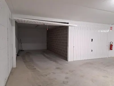 an empty garage with a brick wall at Appartamento Al Borgo in Cles