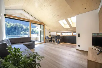 a living room with a couch and a tv at Apartments Dami in Ortisei