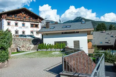 a house with a gate in front of it at Apartments Dami in Ortisei
