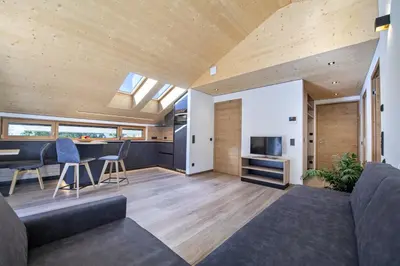 a living room with a couch and a table at Apartments Dami in Ortisei