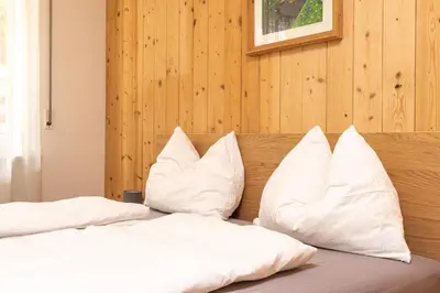 two white pillows on a bed in a room at Ladurner Home in Brunico