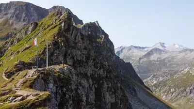 a mountain with a flag on top of it at Ladurner Home in Brunico