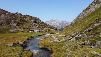 a small house on a mountain with a river at Ladurner Home in Brunico