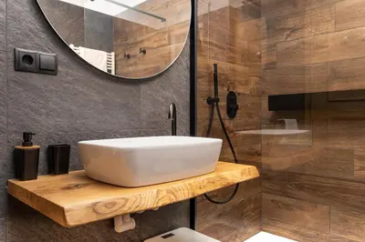 a bathroom with a white sink and a mirror at Ladurner Home in Brunico