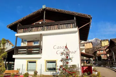 a building with a christmas tree in front of it at Residence Casa Cavalese in Cavalese