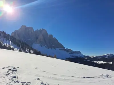 a snow covered slope with a mountain in the background at Groden Apartments in Santa Cristina in Val Gardena