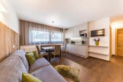 a living room with a couch and a table at Apartments Mezdi in Santa Cristina in Val Gardena