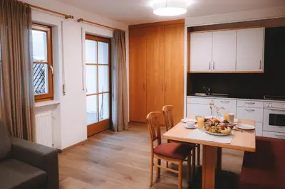 a kitchen with a table with a bowl of fruit on it at Anewandterhof in Brunico