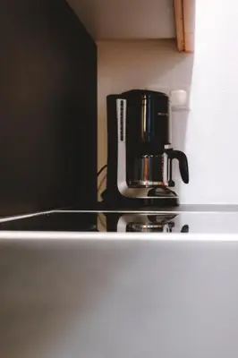 a coffee maker sitting on top of a refrigerator at Anewandterhof in Brunico