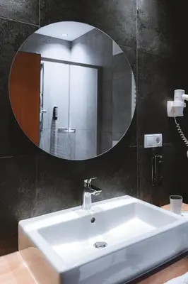 a bathroom with a white sink and a mirror at Anewandterhof in Brunico