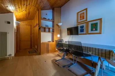 a room with a table and chairs in a room at Casa Val di Fassa in Canazei