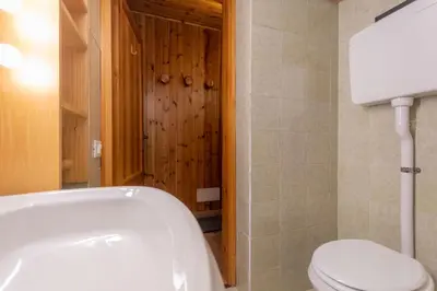 a bathroom with a toilet and a bath tub at Casa Val di Fassa in Canazei