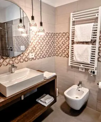 a bathroom with a sink and a toilet at Pitla Cuna - Eco Relais in Terlano