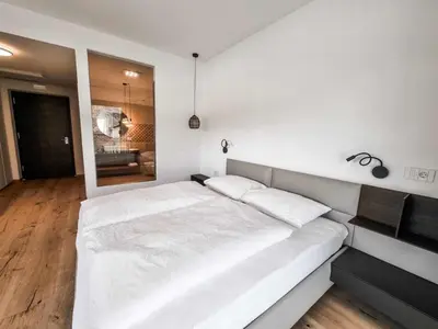 a white bedroom with a large white bed in it at Pitla Cuna - Eco Relais in Terlano