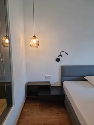 a small room with a bed and a lamp at Pitla Cuna - Eco Relais in Terlano