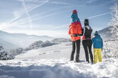 three people standing on top of a snow covered mountain at Peintnerhof Appartments & Zimmer in Naz-Sciaves