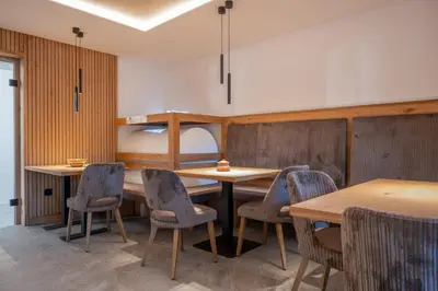a room with tables and chairs and a bunk bed at Peintnerhof Appartments & Zimmer in Naz-Sciaves