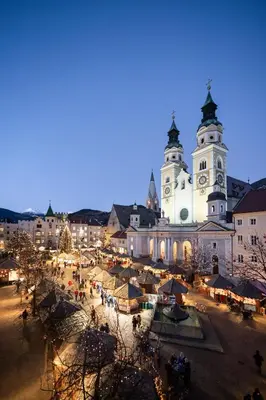 a city with a christmas market in front of a church at Peintnerhof Appartments & Zimmer in Naz-Sciaves