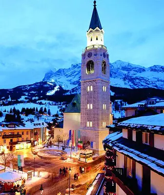 a building with a clock tower in a city at Cortina Comfort House in Cojana