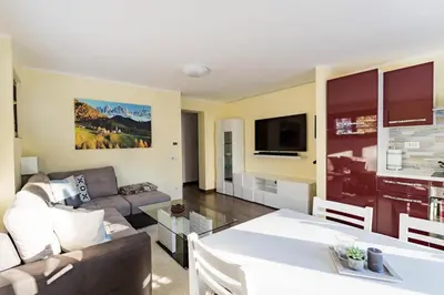 a living room with a couch and a table at Cortina Comfort House in Cojana