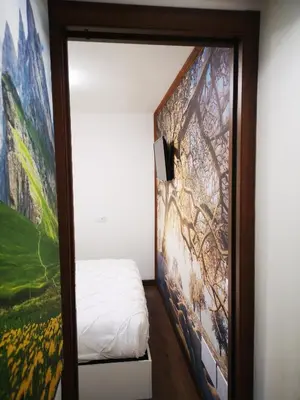 a room with a bed and a painting on the wall at Cortina Comfort House in Cojana